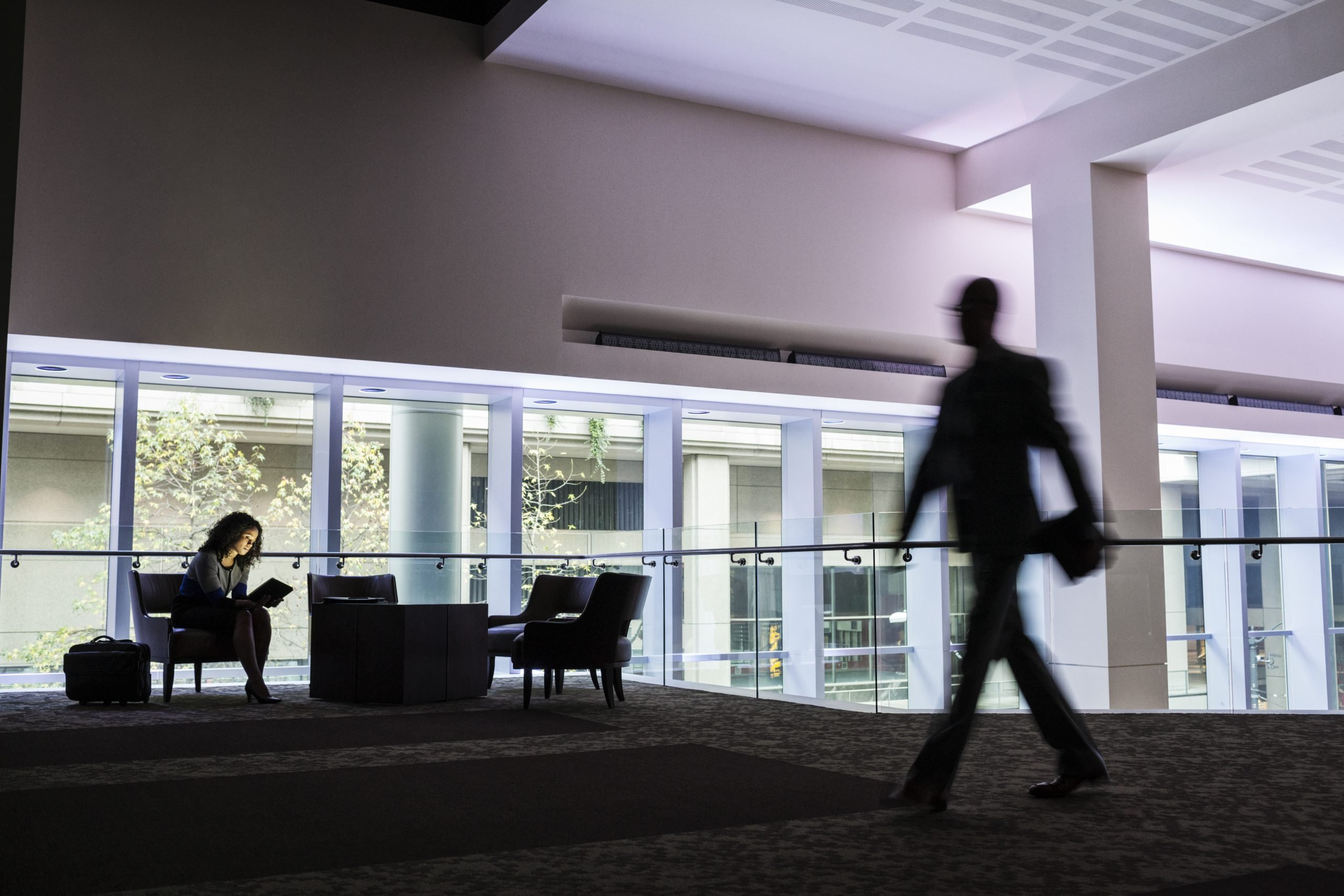 USA,A black businesswoman sitting in front of windows in a darkened lobby area of a convention center. 1 a black businesswoman sitting in front of windows 2026 03 25 02 21 26 utc scaled